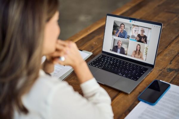 Dekoratives Bild: Frau mit Laptop in Online-Konferenz